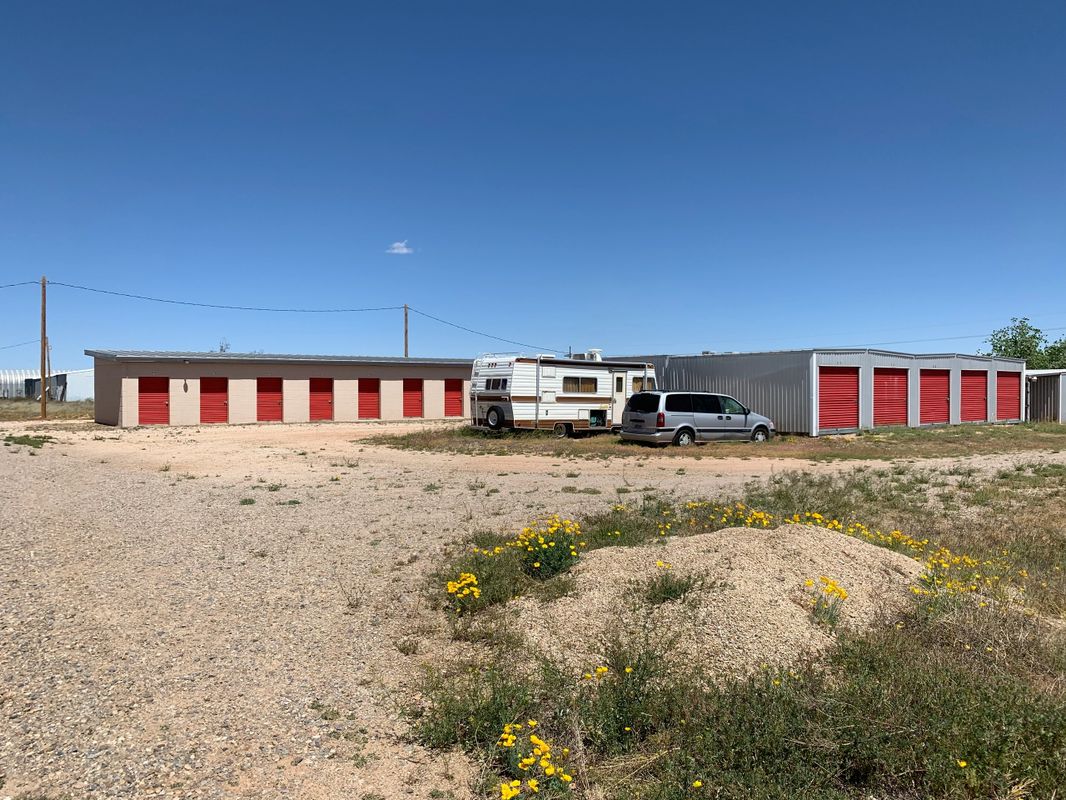 Storage units with red doors and vehicles